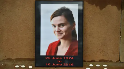 Getty Images Candles surround a photo of Labour MP Jo Cox before a vigil in her memory