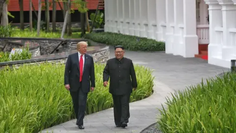 KEVIN LIM/THE STRAITS TIMES/HANDOUT U.S. President Donald Trump (L) and North Korea's leader Kim Jong Un (R) meet for the US-North Korea summit, at the Capella Hotel on Sentosa Island in Singapore on June 12, 2018.