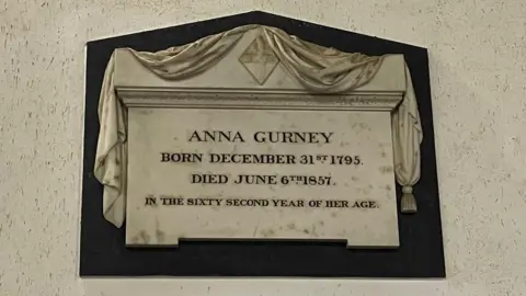 Emma Craig/BBC A stone in Overstrand church which has been inscribed with the dates of Anna Gurney's birth and death. It reads, ANNA GURNEY, BORN DECEMBER 31st 1795. DIED JUNE 6th 1857. IN THE SIXTY SECOND YEAR OF HER AGE.