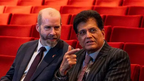 Jonathan Reynolds and India's Minister of commerce and industry Piyush Goyal seated