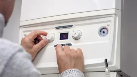 Getty Images Person uses boiler 