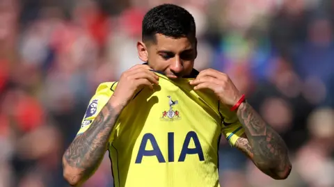 Tottenham's Cristian Romero bites his shirt as he is substituted in their Premier League game against Sunderland