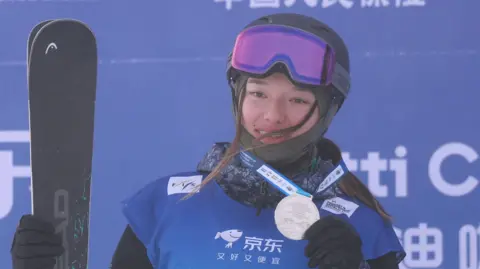 Great Britain's Zoe Atkin celebrates winning silver at a World Cup event in China