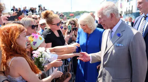 PA Media Queen Camilla and King Charles III meeting well-wishers as they arrive to attend the special sitting of the States of Deliberation, at the Guernsey Parliament in Saint Peter Port, Guernsey, during a two day visit to the Channel Islands.