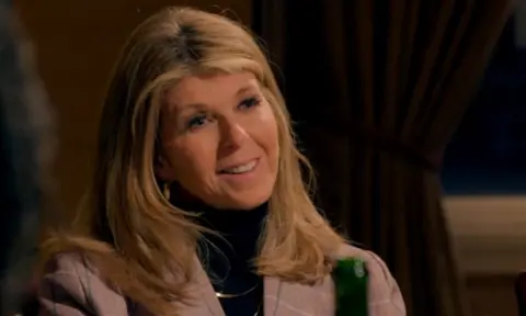 BBC/Studio Lambert Kate Garraway smiling in a grey suit