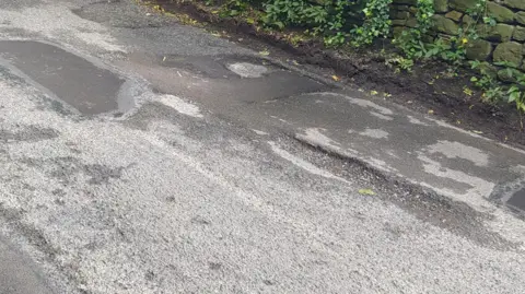 Potholes on Old Neighbourhood Road in Chalford