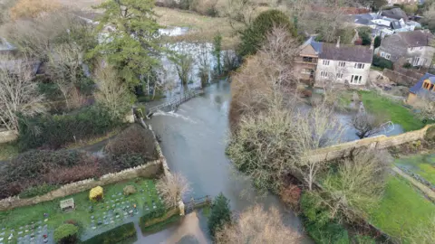 Eric Bird A large pool of water that has overflowed from the River Cerne.