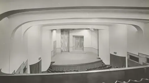 Joseph Rowntree Theatre A black and white picture showing the stage of a theatre built in the art deco style in the mid 1930s
