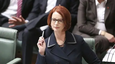Getty Images A female politician sitting in parliament, with short red hair and wearing a dark suit.