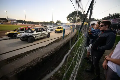 Getty Images Spectators look on as competitors take part in the Southern Shakedown Series banger racing championship at Arlington Stadium on August 09, 2023 in Hailsham, England.