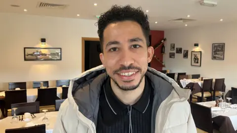 Phototgraph of Mohamed Abdelaziz. He is pictured inside the Bianco Italian restaurant in Hollingworth.