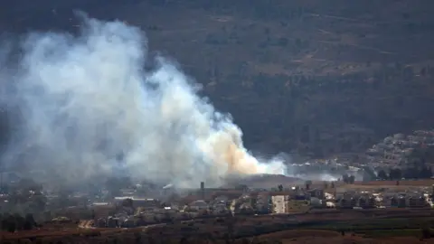 EPA Smoke rises from land near the northern Israeli town of Kiryat Shmona following a Hezbollah rocket attack (3 July 2024)