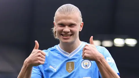 Erling Haaland celebrates by putting his thumbs up after scoring his first goal against Wolves