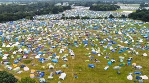 Martin Barber/BBC Field filled with tents