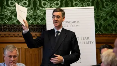 Getty Images Jacob Rees-Mogg holding the report