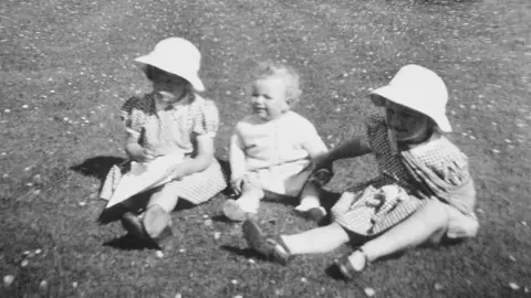 Ann Cleaver/Shutterstock Camilla Parker Bowles, age 4, with her brother Mark Shand and sister Annabel