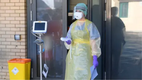 PA Media An nurse during a demonstration of the coronavirus pod and Covid-19 virus testing procedures set-up beside the Emergency Department of Antrim Area Hospital