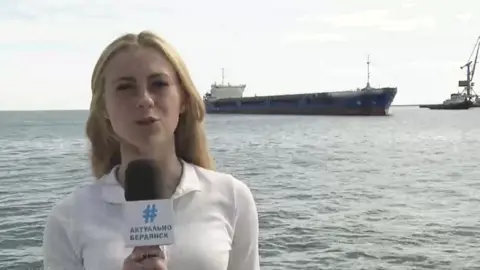 Telegram Screengrab of news reporter standing near the Zhibek Zholy