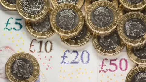 PA Sterling banknotes and £1 coins