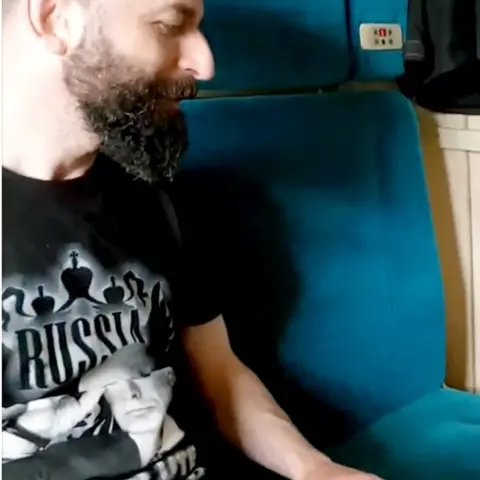 YouTube Nazarro wearing black T-shirt featuring Putin