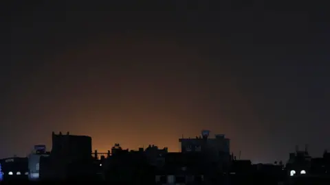 EPA Light shining behind buildings at a neighbourhood following strikes in Sana'a, Yemen on Saturday