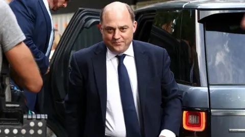 Reuters Defence Secretary Ben Wallace seen exiting a ministerial car