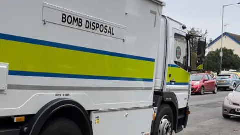 Lauren Fox A bomb disposal van arriving in a street