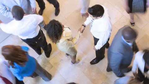 Getty Images Businesspeople in a lobby