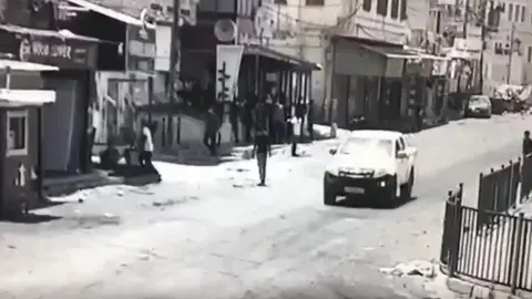 BBC Screengrab of CCTV footage showing Abdul Rahman Hassan Ahmed Hardan standing in a street in Jenin moments before he was shot and killed by Israeli forces during a major military operation in the West Bank city (4 July 2023)