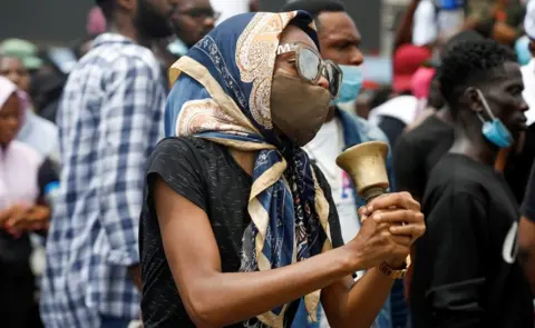 Reuters Woman holding a bell