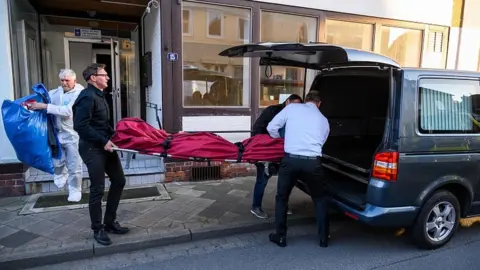 AFP Undertakers carry a body on May 13, 2019 out of a house in Wittingen, northern Germany