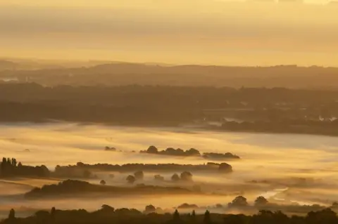 Getty Images The sun rises over the South Downs National Park