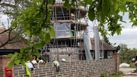 Smock Tower Mill with scaffolding surrounding it