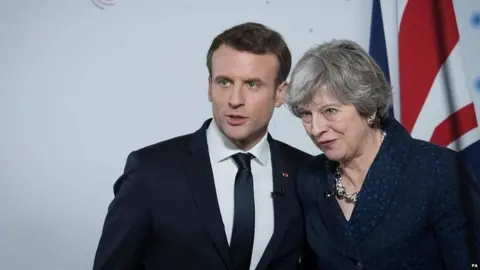 PA Emmanuel Macron and Theresa May