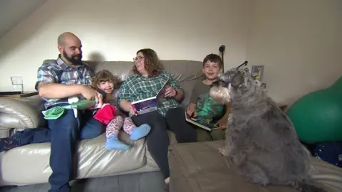 BBC The family sitting on their sofa