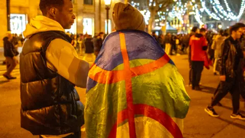 Getty Images A Moroccan football fan draped in a Amazigh flag in Spain - 6 December 2022