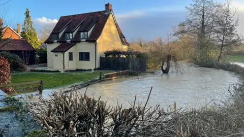 Clayton Hudson Water from river floods house in Pulham St Mary, Norfolk