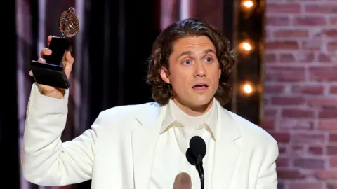 Getty Images Aaron Tveit accepts the award for best actor in a leading role in a musical for Moulin Rouge! The Musical