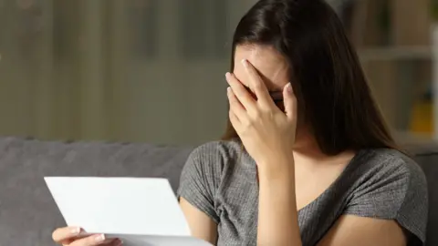 Getty Images Women holding bill