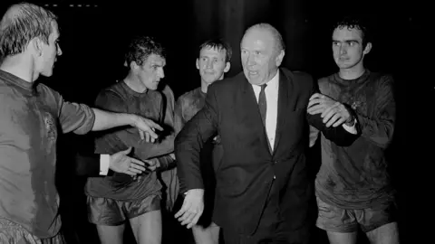 Getty Images (L-R) Bobby Charlton, Bill Foulkes, Paddy Crerand, Matt Busby and John Aston after United's historic '68 European Cup Final win