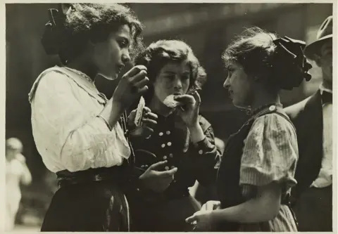 Courtesy of Swann Auction Galleries A group of three children eating.