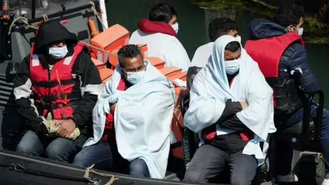 PA Media A group of people thought to be migrants are brought in to Dover, Kent, following a small boat incident in the Channel. Picture date: Thursday June 16, 2022.