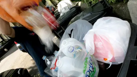 PA Media Waste being emptied into a wheelie bin