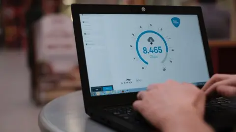 Virgin Media Man on computer with speed test