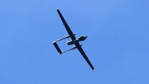 AFP/Getty Images Indian army drone flies near the site of a gunbattle between Indian government forces and suspected militants in Padgampora village of Pulwama, south of Srinagar on 9 March 2017.