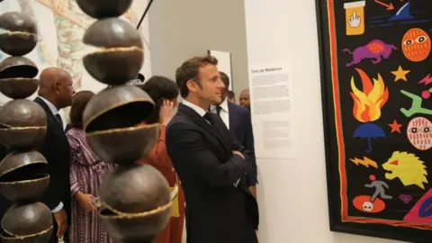 EPA French President Emmanuel Macron attends the opening of a hybrid art exhibition in Cotonou, Benin, 27 June 2022, during the official visit of Macron to the Republic of Benin