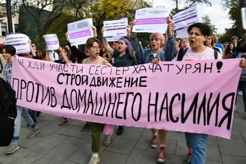 Getty Images The big banner urges people to build a movement against domestic violence (31 August 2018)