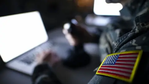 Getty Images Stock photo of a solider at a laptop