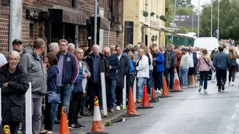 PA Media Fans queue around the Apollo in Manchester ahead of comedian Peter Kay"s charity show to raise money for 20-year-old Laura Nuttall