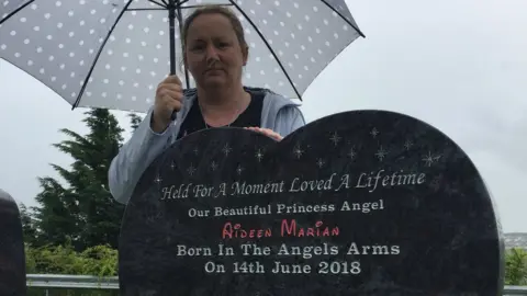 anne marie watkins at her baby's grave